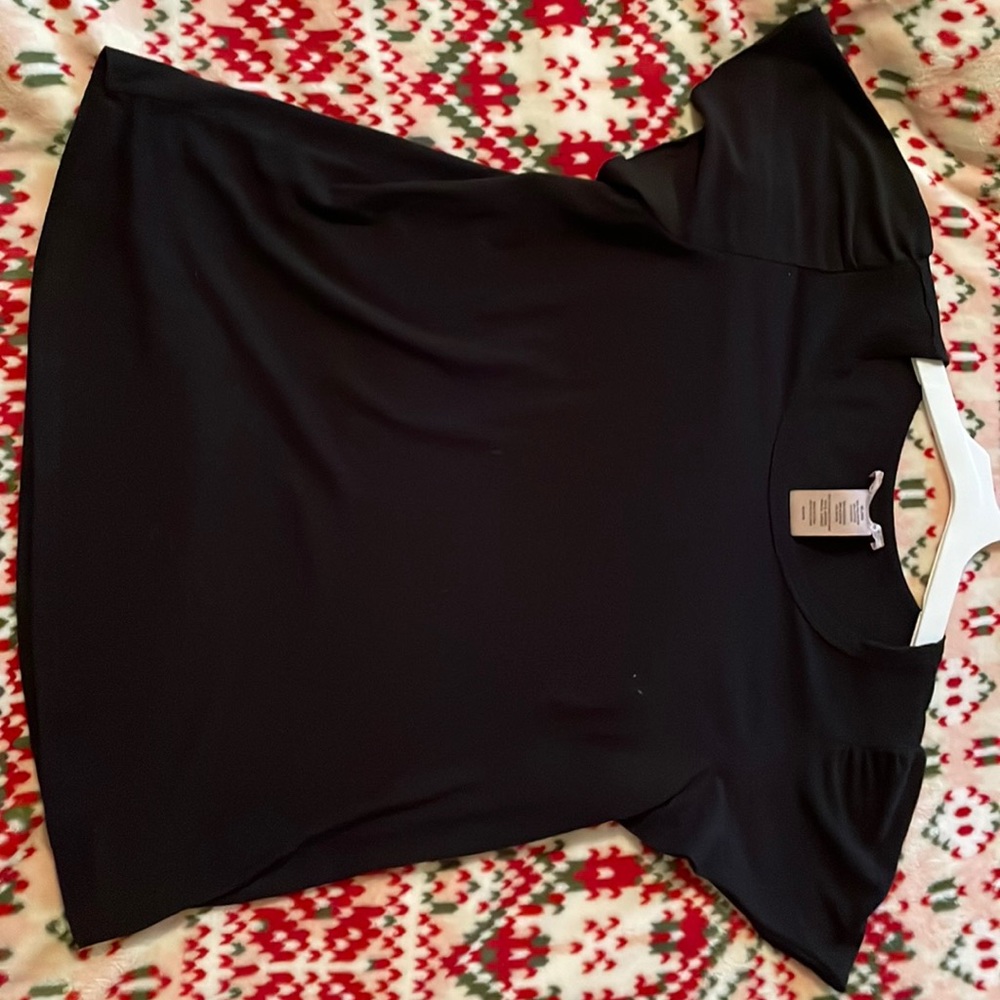 Cute simple black shirt with slight ruffled sleeves.